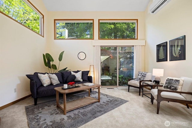 carpeted living room featuring a wall mounted AC, high vaulted ceiling, and baseboards
