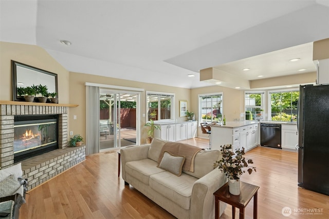 10116 SE 188th St, Renton, WA 98055 - living area with a fireplace, light wood-type flooring, healthy amount of natural light, and recessed lighting