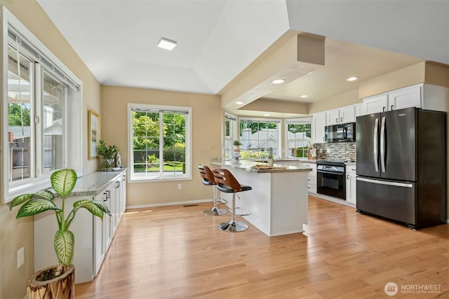 10116 SE 188th St, Renton, WA 98055 - kitchen with black appliances, light wood-type flooring, plenty of natural light, a peninsula, and recessed lighting