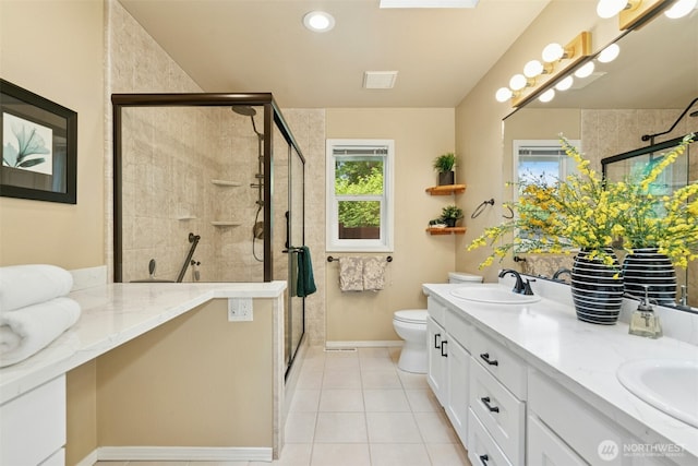 10116 SE 188th St, Renton, WA 98055 - bathroom with double vanity, a shower stall, toilet, tile patterned flooring, and baseboards