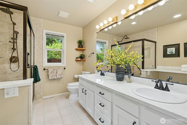 10116 SE 188th St, Renton, WA 98055 - bathroom featuring double vanity, a stall shower, tile patterned floors, toilet, and baseboards
