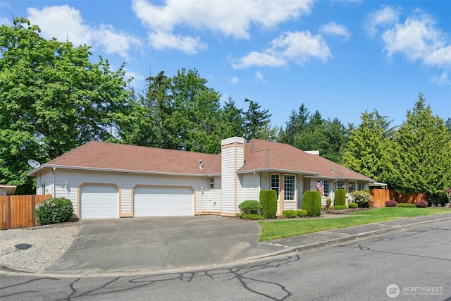 10116 SE 188th St, Renton, WA 98055 - view of front of house featuring an attached garage, asphalt driveway, and a chimney