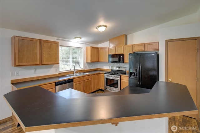 kitchen with a kitchen breakfast bar, a sink, dark countertops, lofted ceiling, and black appliances