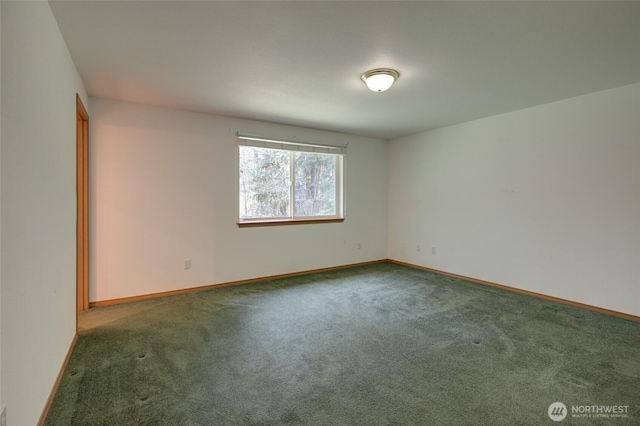 empty room with baseboards and carpet floors
