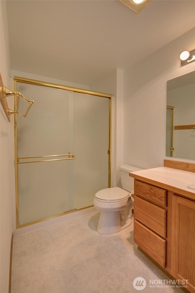 full bath featuring vanity, toilet, and a stall shower