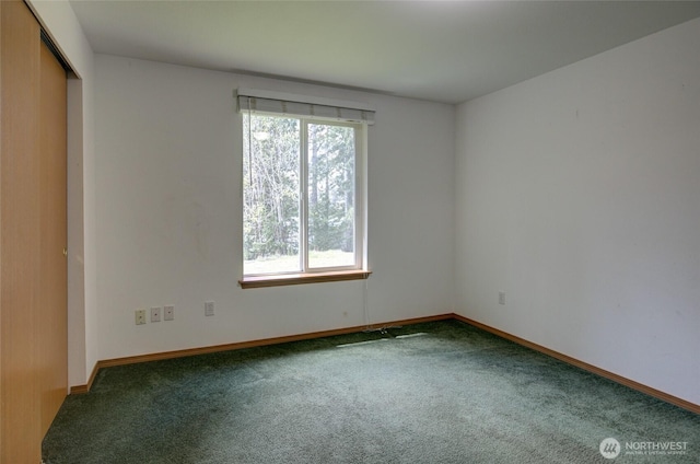 spare room with carpet floors and baseboards