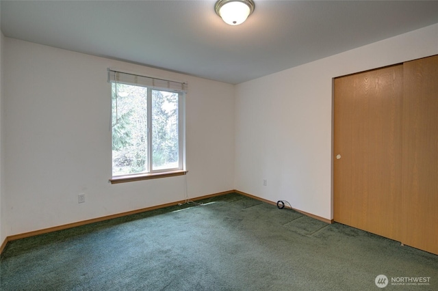 unfurnished bedroom with baseboards and carpet