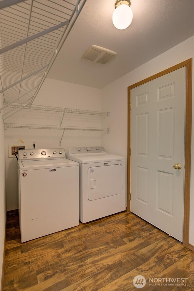 laundry room with visible vents, wood finished floors, laundry area, and independent washer and dryer