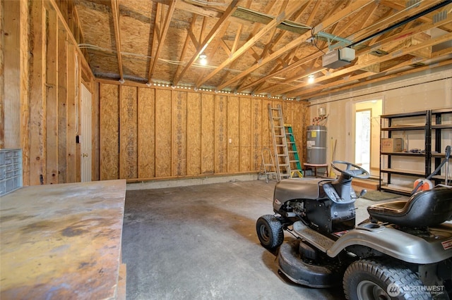 garage with secured water heater and a garage door opener