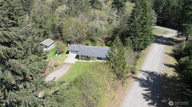 drone / aerial view featuring a wooded view