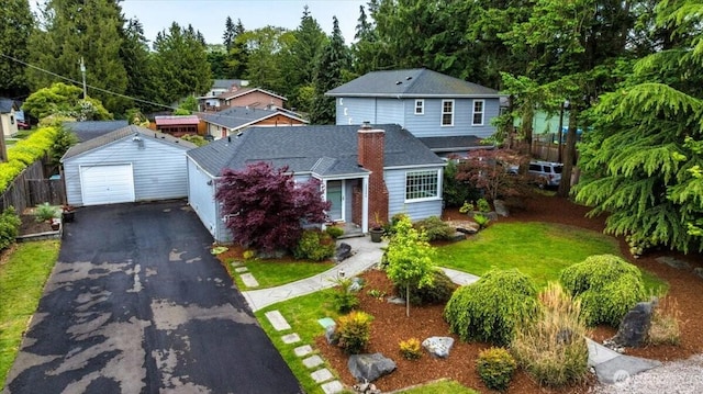 traditional-style house with an outbuilding, a detached garage, and driveway