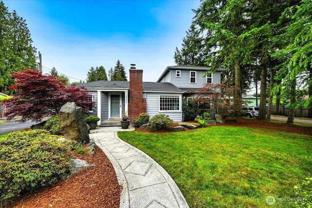 traditional home with a front lawn and a chimney