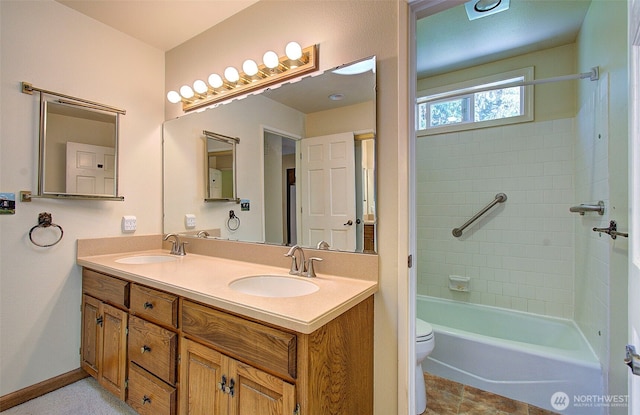 bathroom featuring double vanity, toilet, shower / bathtub combination, and a sink