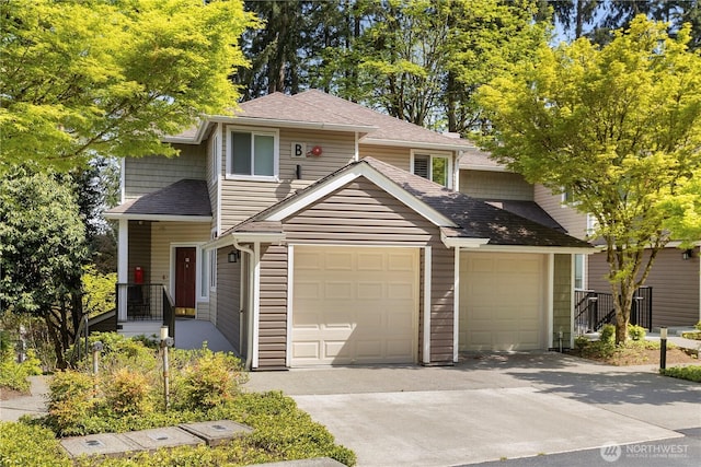 traditional-style house featuring roof with shingles and concrete driveway
