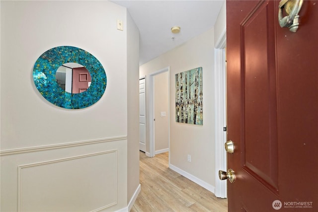 entrance foyer featuring light wood-style floors and baseboards