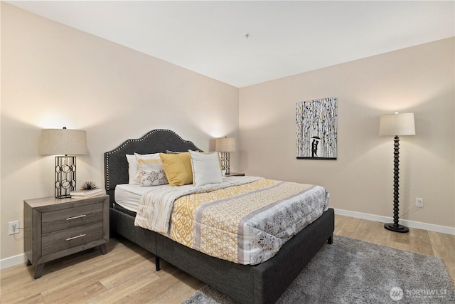 bedroom featuring baseboards and light wood-style floors
