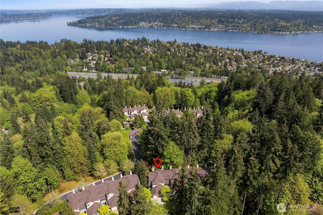 aerial view with a water view and a forest view