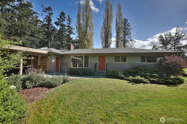 ranch-style house with a chimney and a front yard