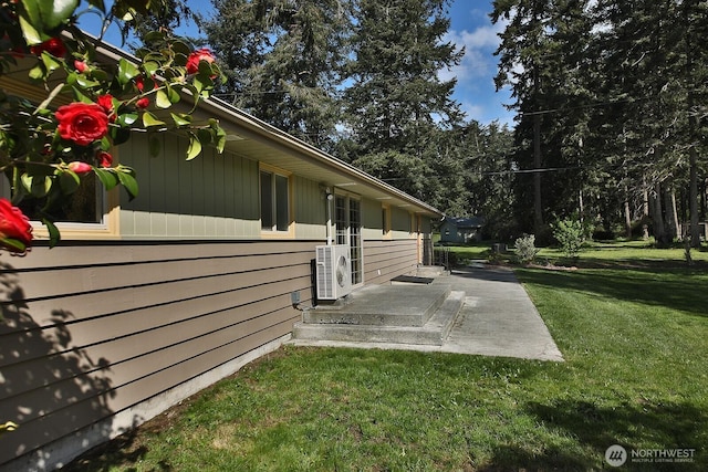view of property exterior with a patio area, ac unit, and a yard