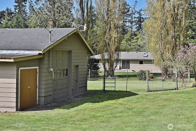 view of yard featuring an outdoor structure and fence