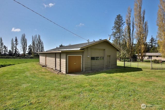 detached garage featuring fence