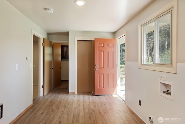 entrance foyer featuring light wood-style flooring and baseboards