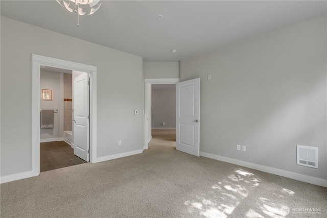 15700 116th Ave NE Unit 205, Bothell, WA 98011 - unfurnished bedroom featuring ensuite bath, baseboards, carpet flooring, and visible vents