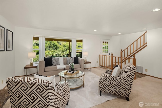 carpeted living area with stairway, recessed lighting, and visible vents