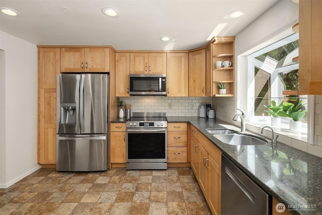 kitchen featuring appliances with stainless steel finishes, tasteful backsplash, open shelves, a sink, and baseboards