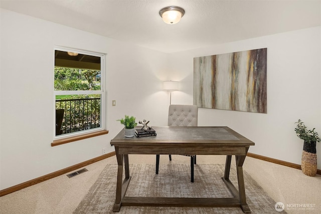 carpeted home office featuring baseboards and visible vents
