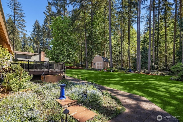 view of yard featuring a deck, an outbuilding, and a storage unit