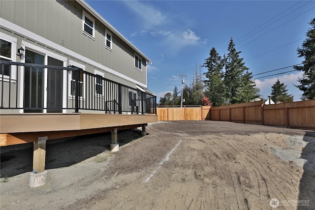 view of yard featuring fence and a deck