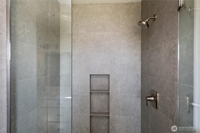 bathroom with a tile shower