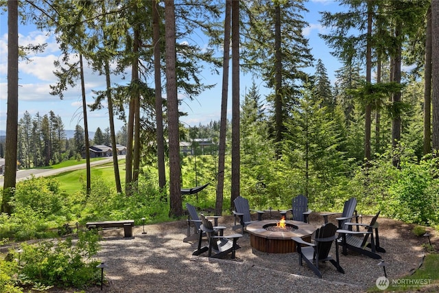 surrounding community with an outdoor fire pit
