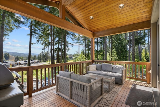 wooden deck with an outdoor living space and grilling area