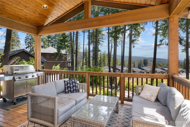 wooden terrace with a residential view, a grill, and outdoor lounge area