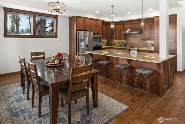 dining area featuring recessed lighting, baseboards, and dark wood finished floors