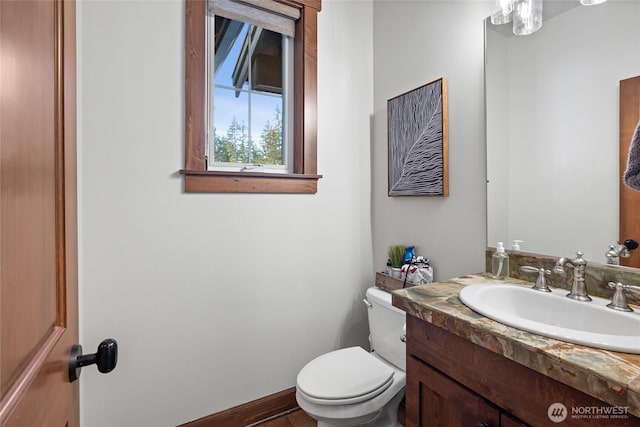 bathroom featuring toilet and vanity