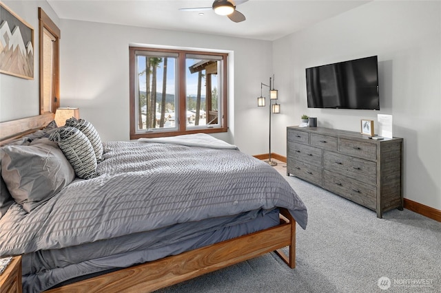 carpeted bedroom featuring a ceiling fan and baseboards