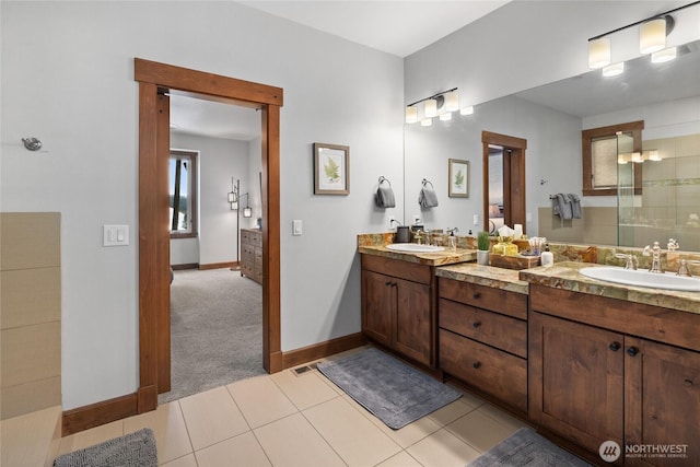 full bathroom featuring double vanity, tile patterned floors, and a sink