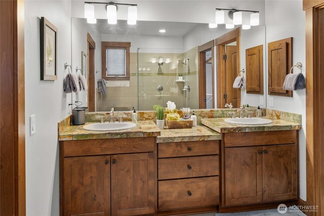 full bath featuring a sink, a stall shower, and double vanity