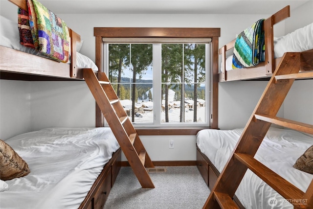 carpeted bedroom featuring baseboards