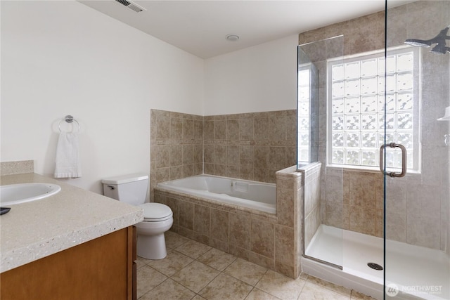 full bath featuring tile patterned flooring, plenty of natural light, a shower stall, and toilet