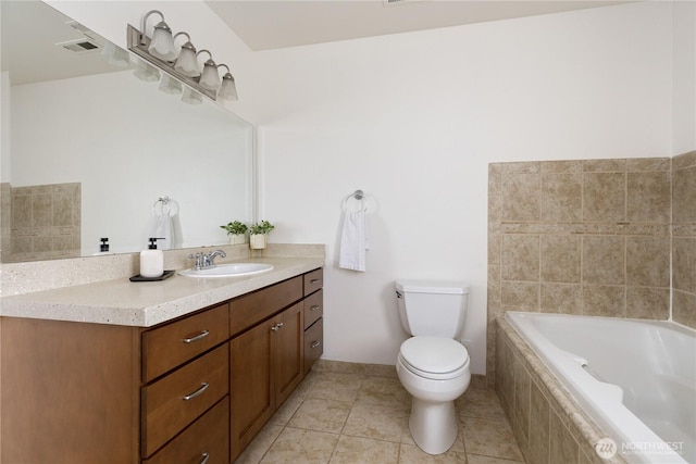 bathroom featuring tiled tub, visible vents, tile patterned flooring, vanity, and toilet