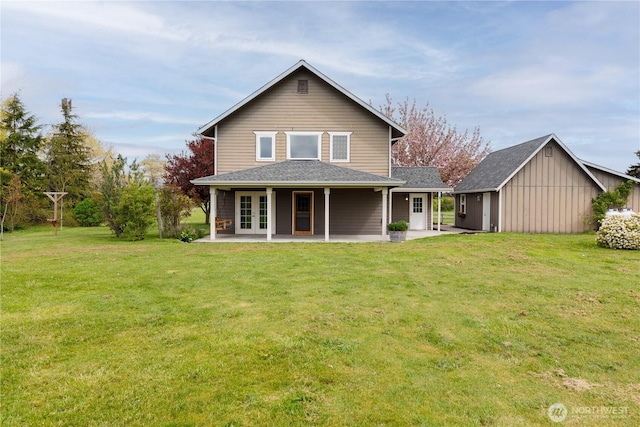 back of house with french doors, a patio, and a yard