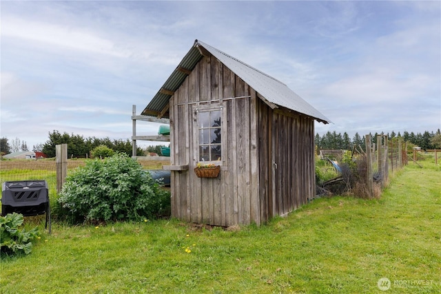 view of shed featuring fence