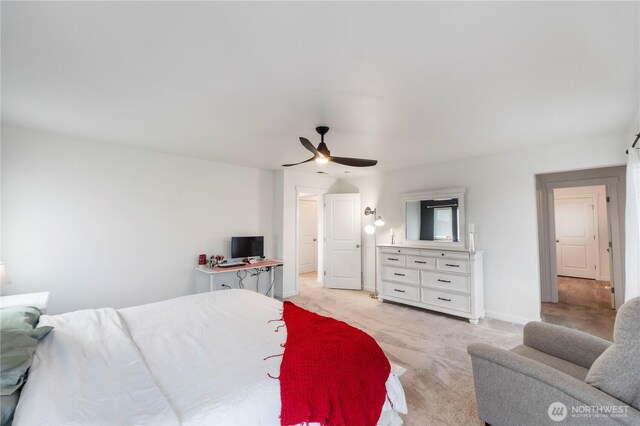 bedroom with light carpet and a ceiling fan