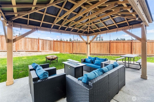 view of patio / terrace featuring a gazebo, a fenced backyard, and an outdoor living space with a fire pit