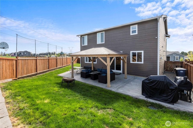 rear view of property with a lawn, a gazebo, an outdoor hangout area, and a fenced backyard
