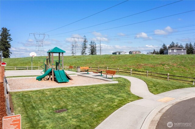 community playground featuring fence and a yard